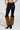 The person wears SIREN FUR TRIM FAUX LEATHER PANTS along with brown faux fur leg warmers and black pointed-toe high-heeled shoes. The image focuses on their lower body against a plain background.