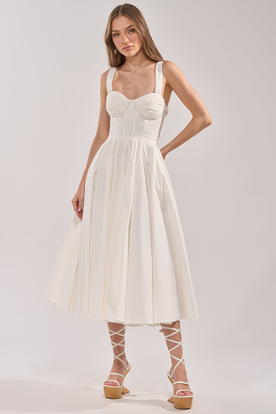fitted poplin dress Large frills at the shoulders give this feminine cotton poplin dress a striking silhouette as they give way to a fitted bodice with gathers at the neck and a skirt that falls to mid calf. Gathering