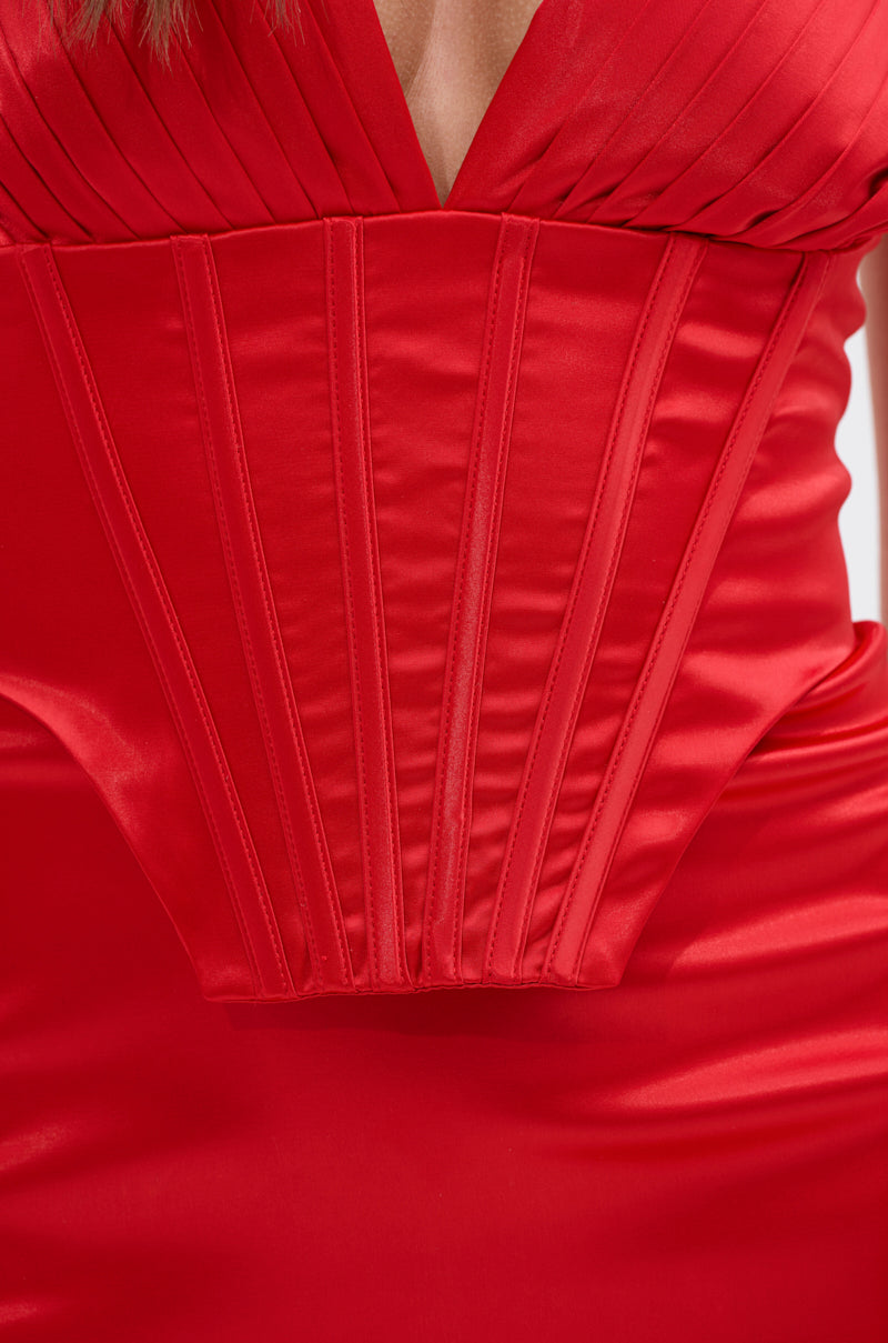 Close-up of a person wearing the ALL ABOUT ME SATIN MAXI DRESS, featuring a shiny, fitted satin design with a structured corset-inspired bodice and pleated detailing accenting the plunging neckline.