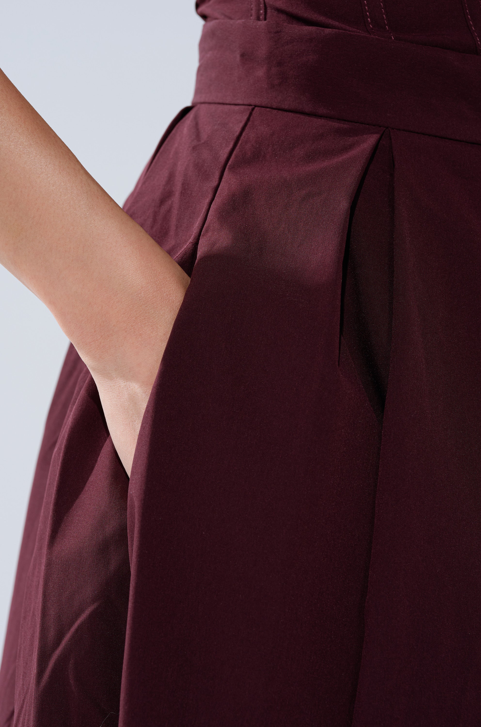 A hand rests in the pocket of the LOVE THIS FOR YOU MAXI SKIRT IN BROWN, displayed in close-up against a plain light background. 9