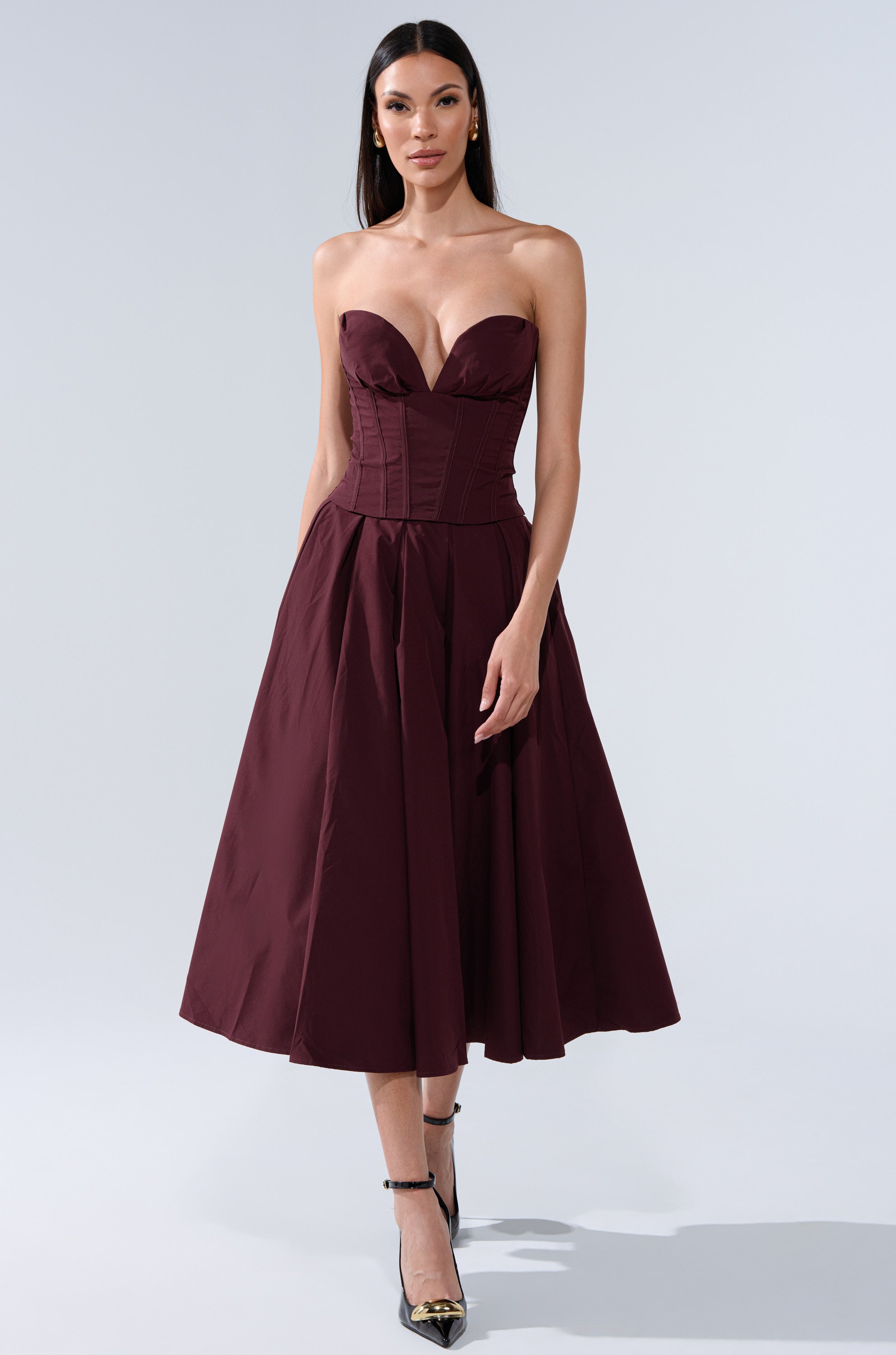 A woman in the LOVE THIS FOR YOU Maxi Skirt in brown, styled with black high heels, stands against a plain light background. 6
