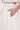 A close-up of a hand in the pocket of the GIRL POWER MIDI SKIRT, showing its A-line silhouette and high-waisted, cream-colored waistband with a matching top just visible above.