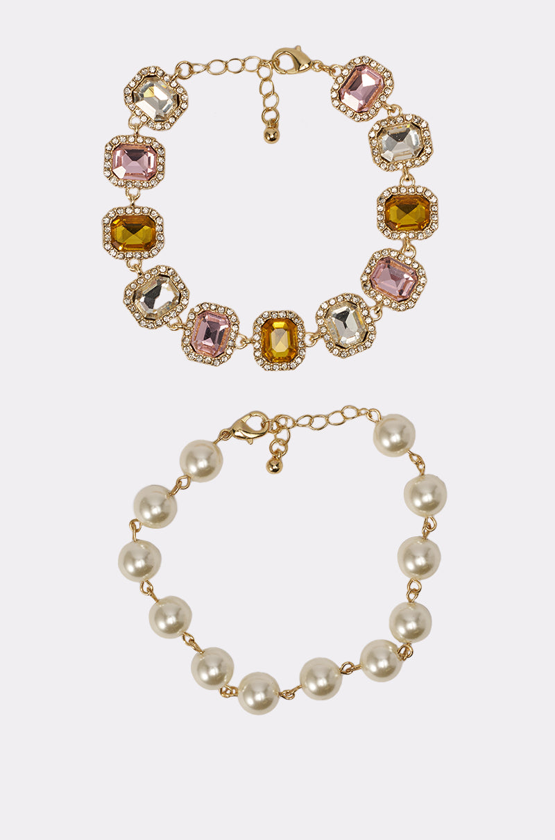 The REGENCY BRACELET SET includes a vibrant gemstone tennis bracelet with sparkling accents and an elegant faux pearl bracelet, both featuring adjustable chain clasps for a perfect fit. 2