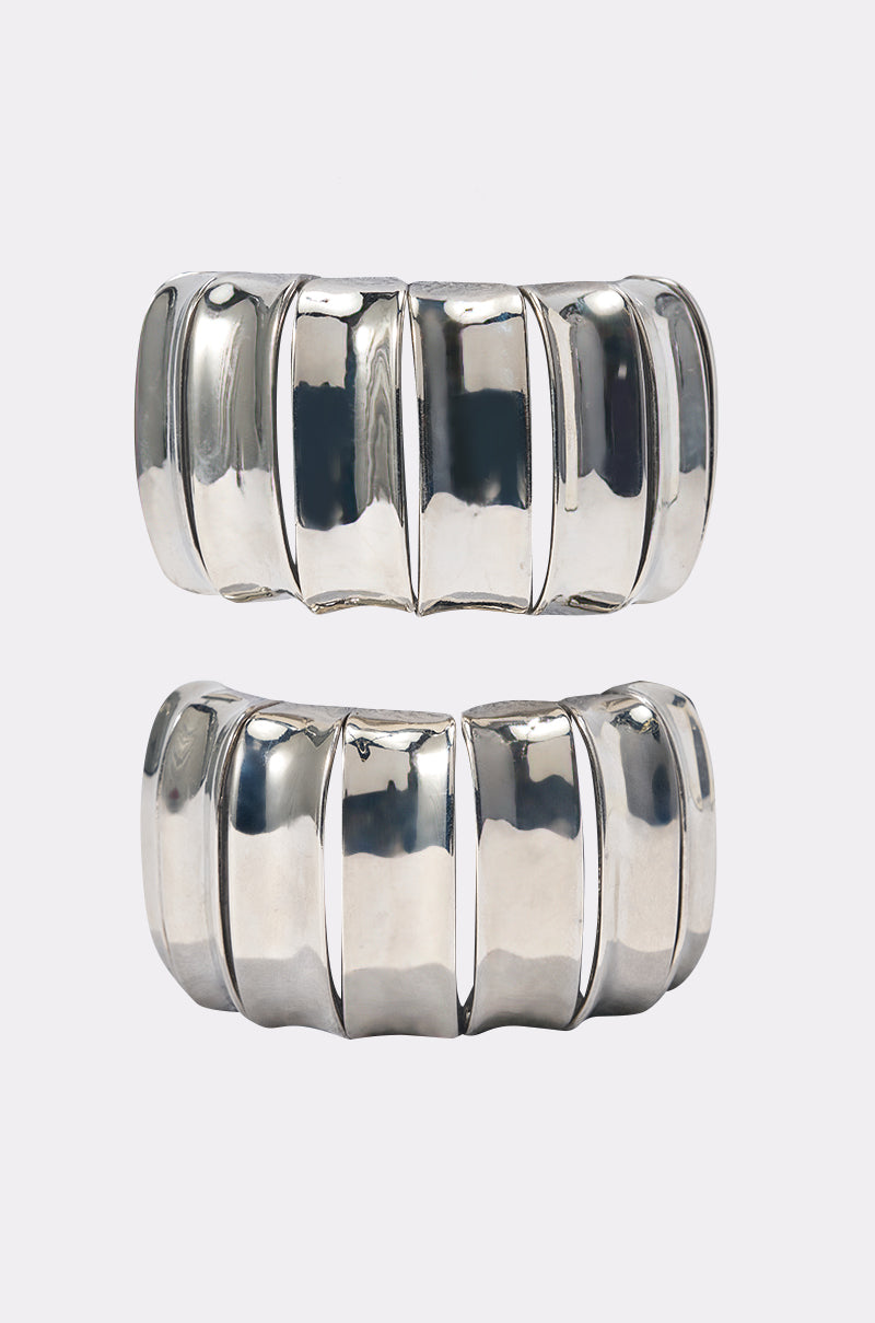 The ULTIMATE CUFF SET features two shiny, chunky silver cuff bracelets with a bold, segmented rectangular design, displayed side by side on a plain white background. 2