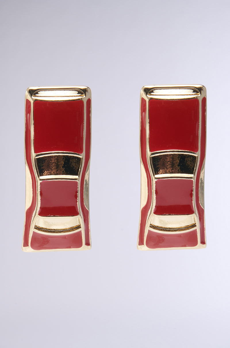 The "I DRIVE FAST STUD EARRINGS," featuring a vintage design of miniature sports cars in gold and cherry red enamel, are displayed against a plain gray backdrop.