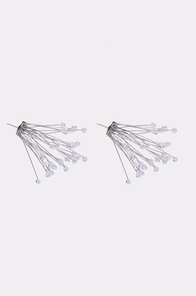 The IN PARIS EARRING features multiple silver wires fanning outward, each tipped with a small clear bead, creating a bold starburst design. Displayed on a plain white background, these earrings are a striking statement accessory. 2