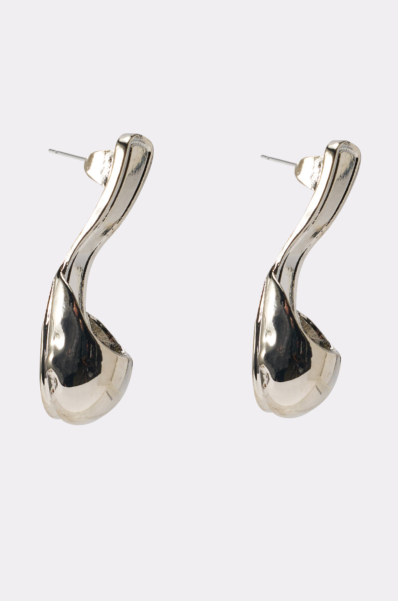 The WALK IN MY SHOES EARRING features shiny silver, sculptural drop shapes with curved abstract design and posts for pierced ears, photographed on a plain white background. 1