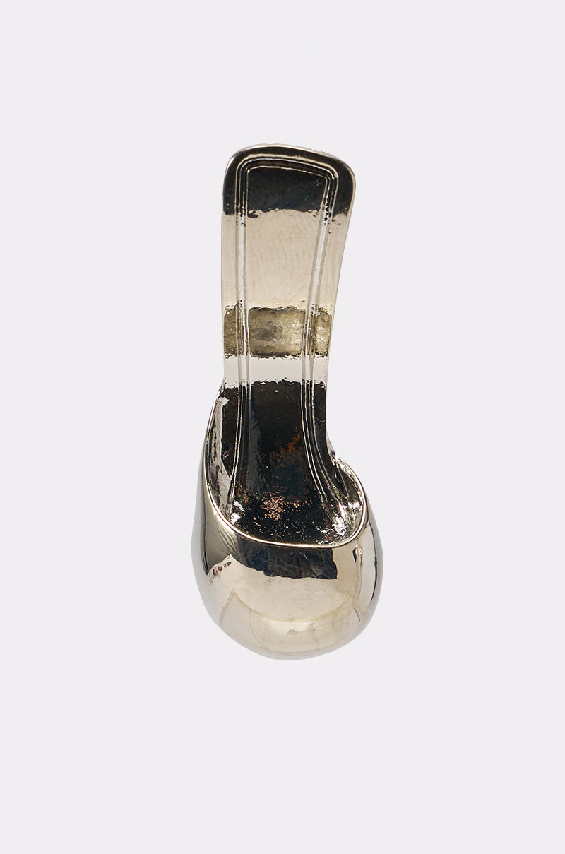 The WALK IN MY SHOES EARRING, featuring a shiny metallic finish and a curved, modern design inspired by fashion-forward earrings, is displayed against a plain light background. 3