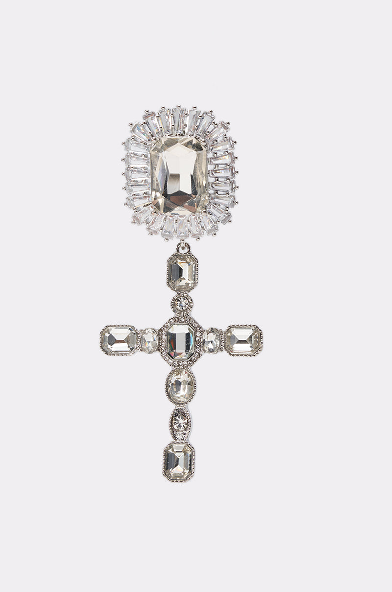 The CROSS YA HEART EARRING features a silver cross design with rectangular clear gemstones and a large ornate top gem—ideal for pairing with crystal earrings for a striking look, all set against a plain white background. 2
