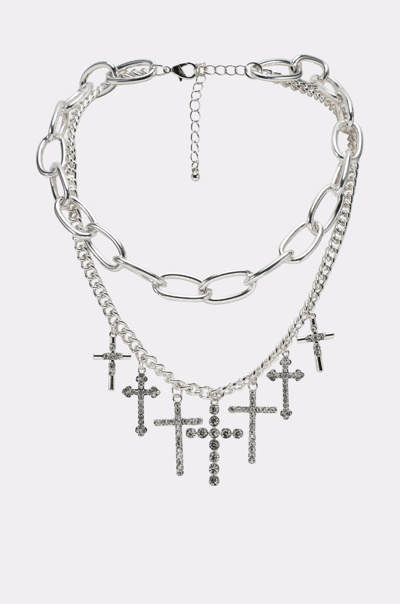The CROSS MY HEART SILVER NECKLACE features layered large chain links and a finer curb chain, finished with multiple sparkling rhinestone pendants hanging at the front. 0