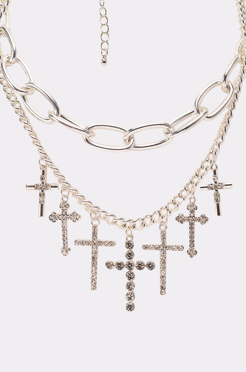 The CROSS MY HEART SILVER NECKLACE features layered large chain links and smaller chains, decorated with multiple rhinestone cross pendants for a bold, contemporary style. 2