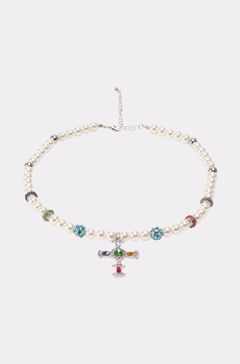 The CANDY CROSS NECKLACE features faux pearls, colorful beaded accents, and a central jeweled pendant with multicolored gemstones, displayed on a plain light background. 1