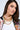 A woman with long brown hair wears the BUY ME THIS NECKLACE—a faux gold, layered chain with a padlock charm—over a white top and colorful patterned jacket. She has natural makeup and looks confidently at the camera.