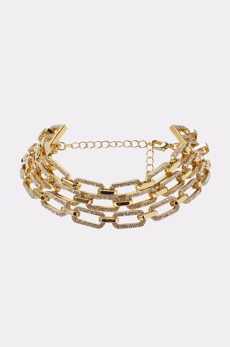 The MY HERO STATEMENT NECKLACE features three rows of rectangular interlocking links with sparkling clear gemstones and an adjustable clasp, displayed on a plain white background.