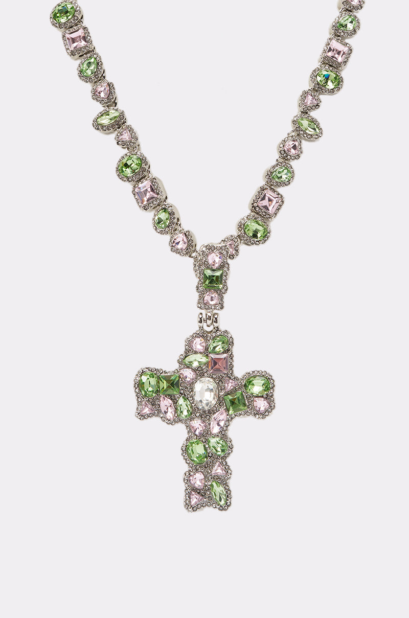 The STAY PROTECTED NECKLACE showcases alternating green and light pink gemstones with a bold cross pendant, all set in ornate silver—perfect festival jewelry, displayed on a plain white background. 2