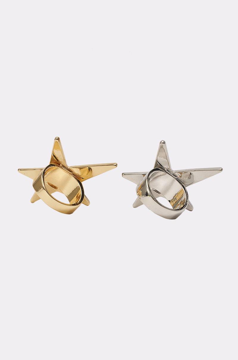 The IM THE STAR RING SET features two star-shaped metallic rings, one gold and one silver, displayed side by side on a plain white background—a bold mixed-metal set perfect for making a statement. 4