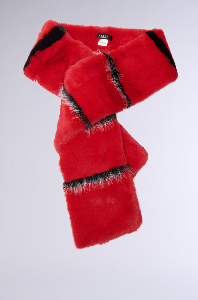The NEVER BUGGIN FAUX FUR SCARF is a chic accessory featuring red faux fur with black and gray striped patterns. Its bold stripes and plush texture offer a stylish and vibrant appearance, set against a plain background.