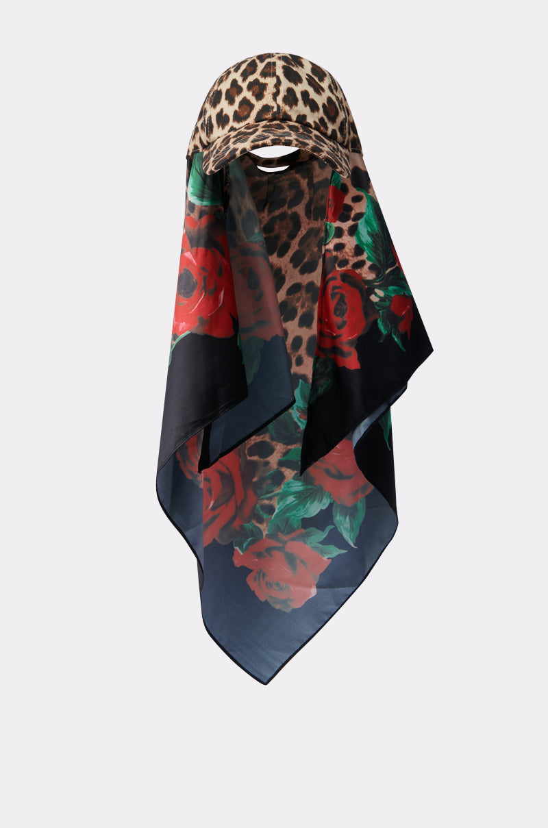 The DOLCE LOVE HAT AND SCARF features a leopard print top, blending into sheer fabric adorned with red roses and green leaves on a dark background. 2