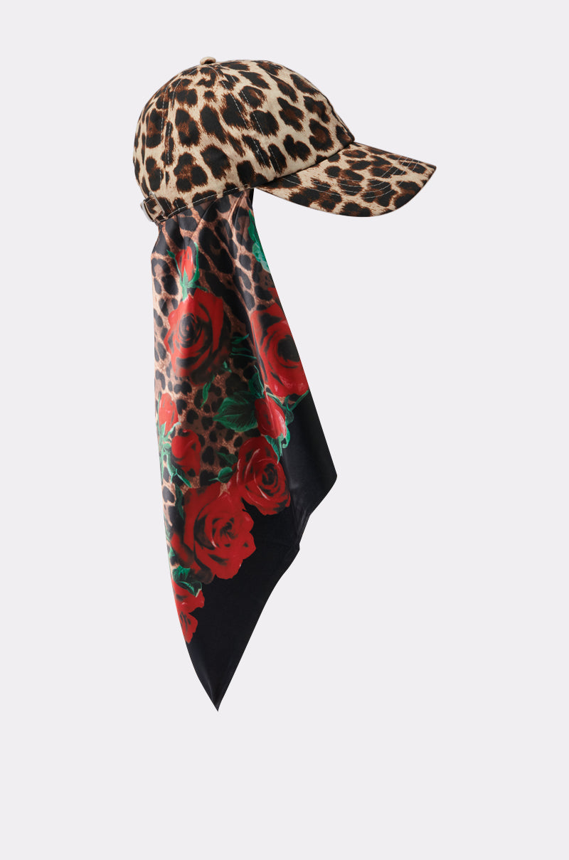 The DOLCE LOVE HAT AND SCARF features a leopard print baseball cap with an attached long floral scarf adorned with a bold red rose pattern, gracefully draping from the back. 3