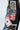 Close-up of black embellished Queen of Hearts Printed and Embellished Denim Pants with vibrant playing card graphics, including aces and hearts, plus a "LOVE" patch with a red diamond.