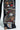 Close-up of QUEEN OF HEARTS PRINTED AND EMBELLISHED DENIM PANTS shows black pants adorned with vivid playing card graphics, featuring a woman with a red rose and a leopard. Additional heart and spade motifs add artistic flair, hinting at Queen Of Hearts themes.