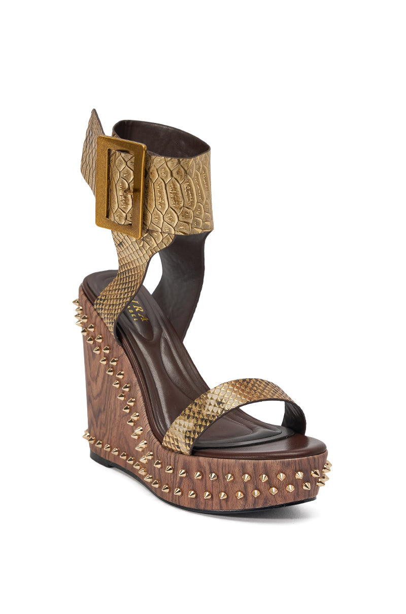 The AKIRA GOLD SLOANE BROWN STUD AND SNAKE WEDGE SANDAL features a high wedge with gold studs, metallic snakeskin ankle and toe straps, and a statement buckle for bold, edgy style. 4
