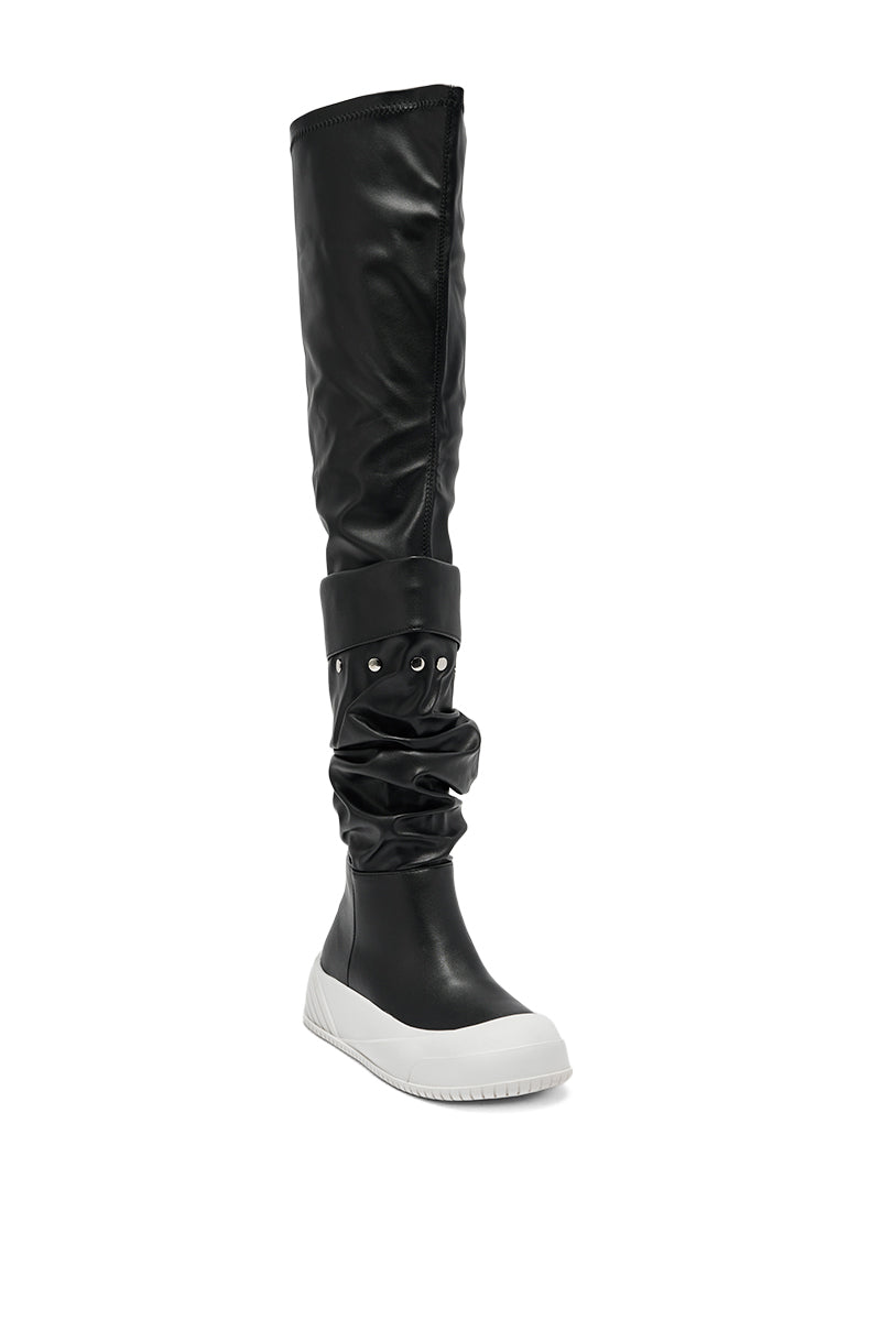 The AZALEA WANG SMARTER BLACK RUCHED PU FLAT BOOT features shiny ruched black PU, a loose slouched upper with wide cuff, chunky white rubber flat sole, and rounded toe.