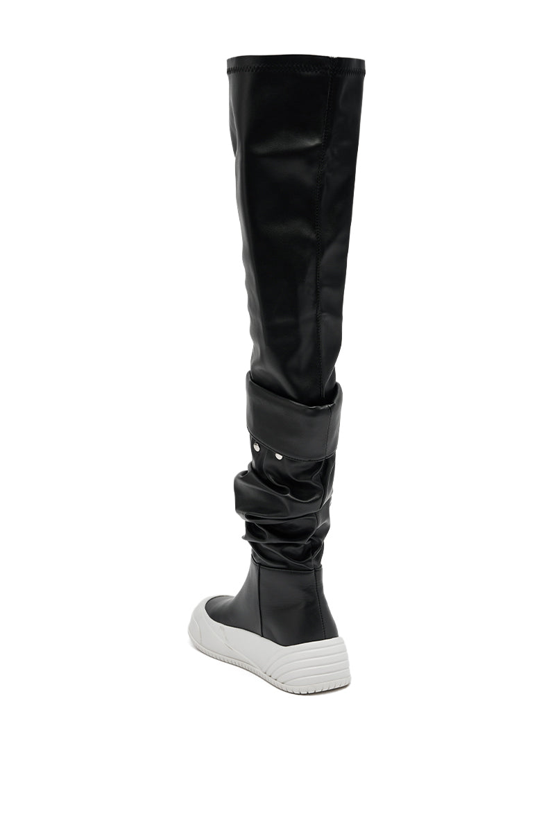 The AZALEA WANG SMARTER BLACK RUCHED PU FLAT BOOT is shown from the back, featuring a slouchy black design and thick white flat sole, set against a white background.