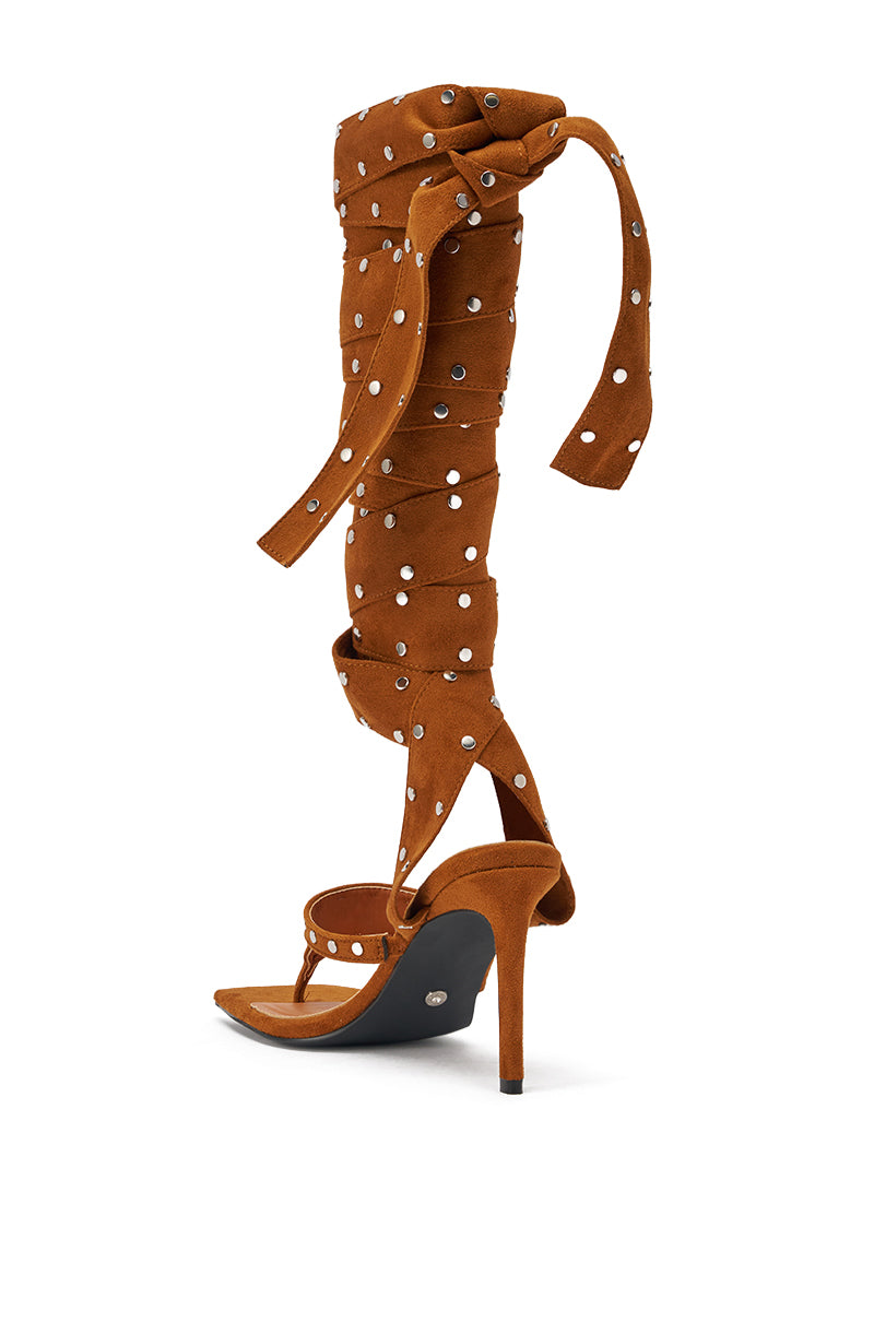The AZALEA WANG SODALITE COGNAC strappy faux suede sandal features a brown lace-up design with an open toe, long wrap-around studded straps, and a heeled silhouette that ties up the leg. 4