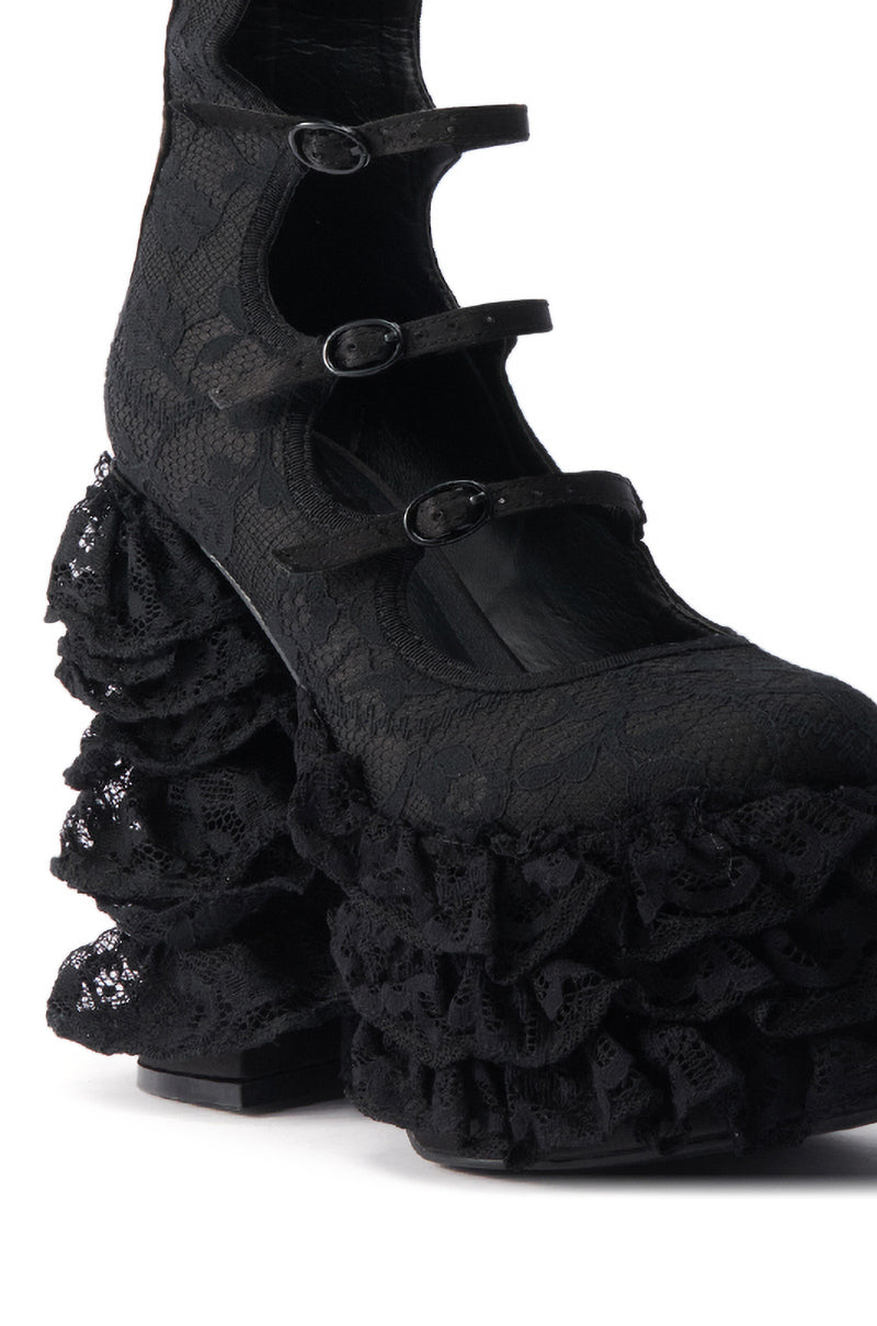 The AZALEA WANG SPREENE FRILL LACE PUMP IN BLACK features three straps and ruffled lace detailing over its chunky heel and platform, delivering a dramatic, textured Gothic Chic look.