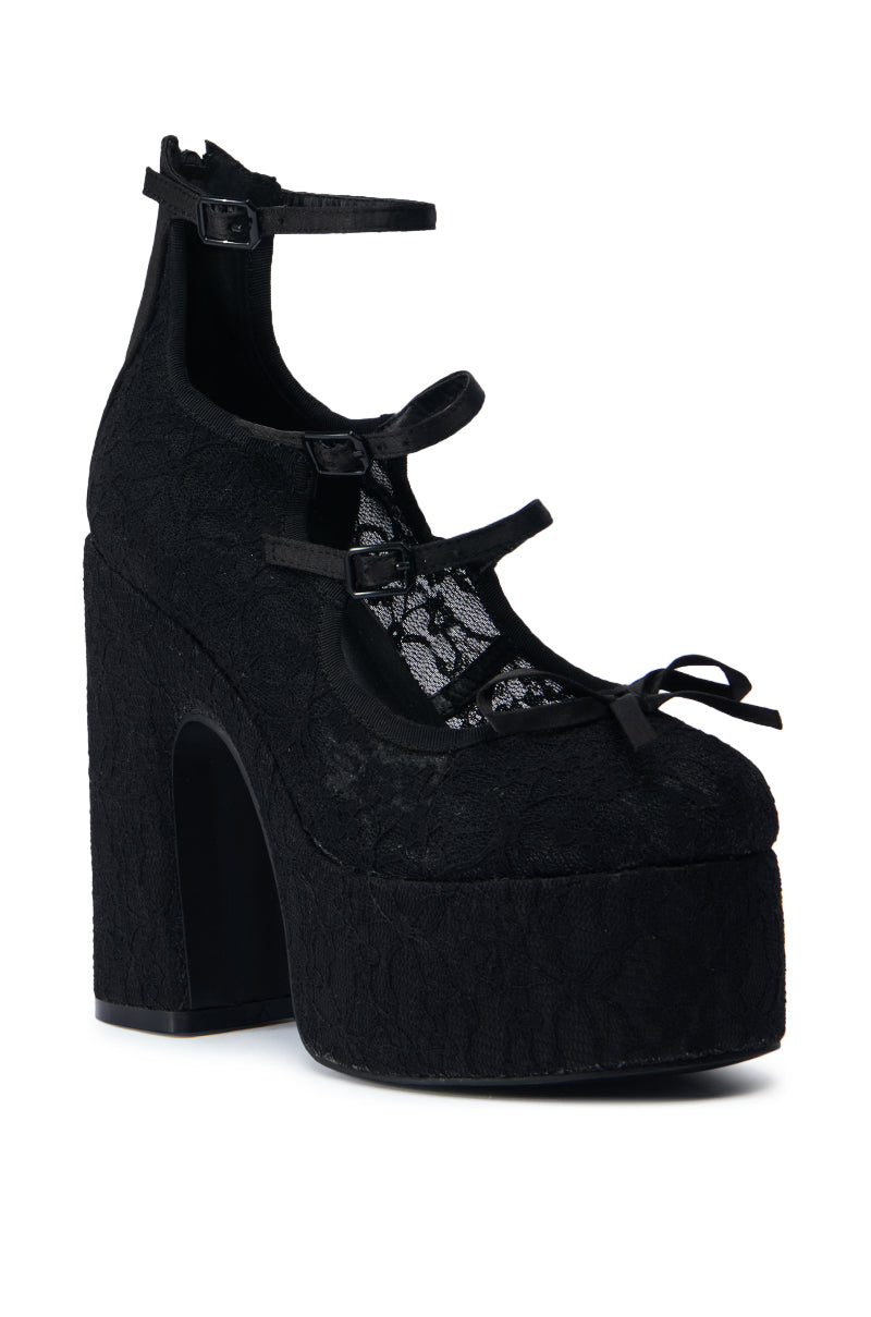 The AZALEA WANG SPROUT BLACK PUMP is a high-heeled platform shoe in black, featuring a lace upper with a chunky heel. It includes three straps with buckles and offers a closed-toe design adorned with a small bow, alongside a comfort cushion insole for enhanced ease.