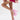 A person poses with one leg bent in a pink and gold floral lace skirt, wearing AZALEA WANG SPROUT PINK CHUNKY PUMP platform heels with ankle straps against a plain white background.