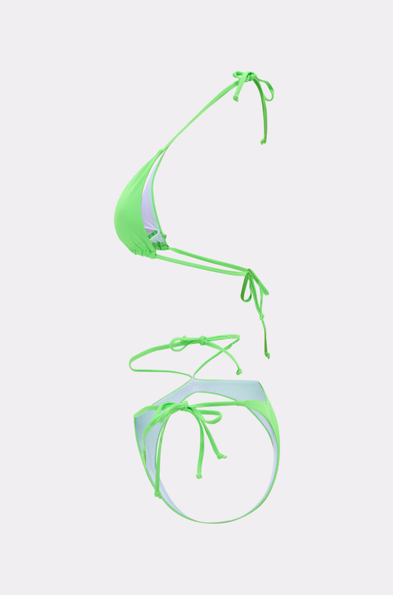 The CUT IT OUT SWIM SUIT is a neon green string bikini set made from stretch swim fabric with triangle top and bottom, adjustable tie straps, shown on a plain white background.