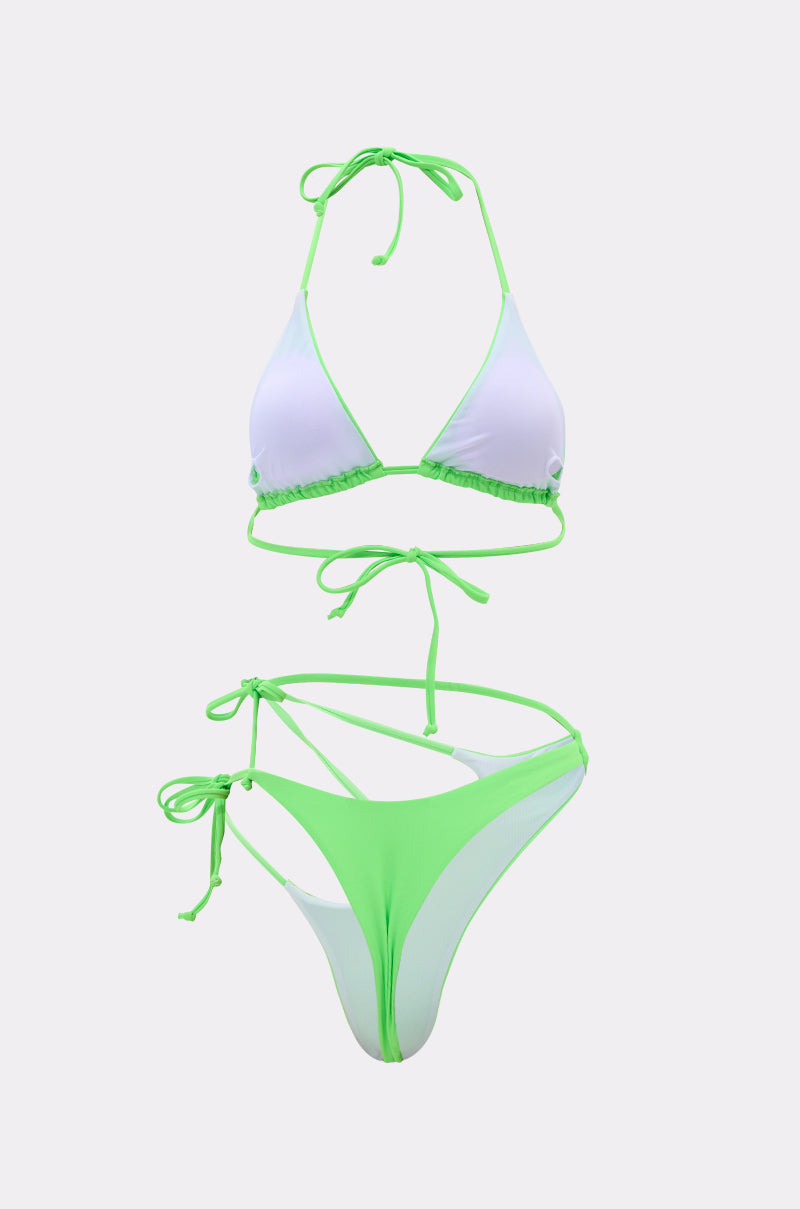 The CUT IT OUT SWIM SUIT is a neon bikini in lime green and white color blocks, featuring a halter-neck triangle top with string ties, made from stretch swim fabric and shown on a plain light background.