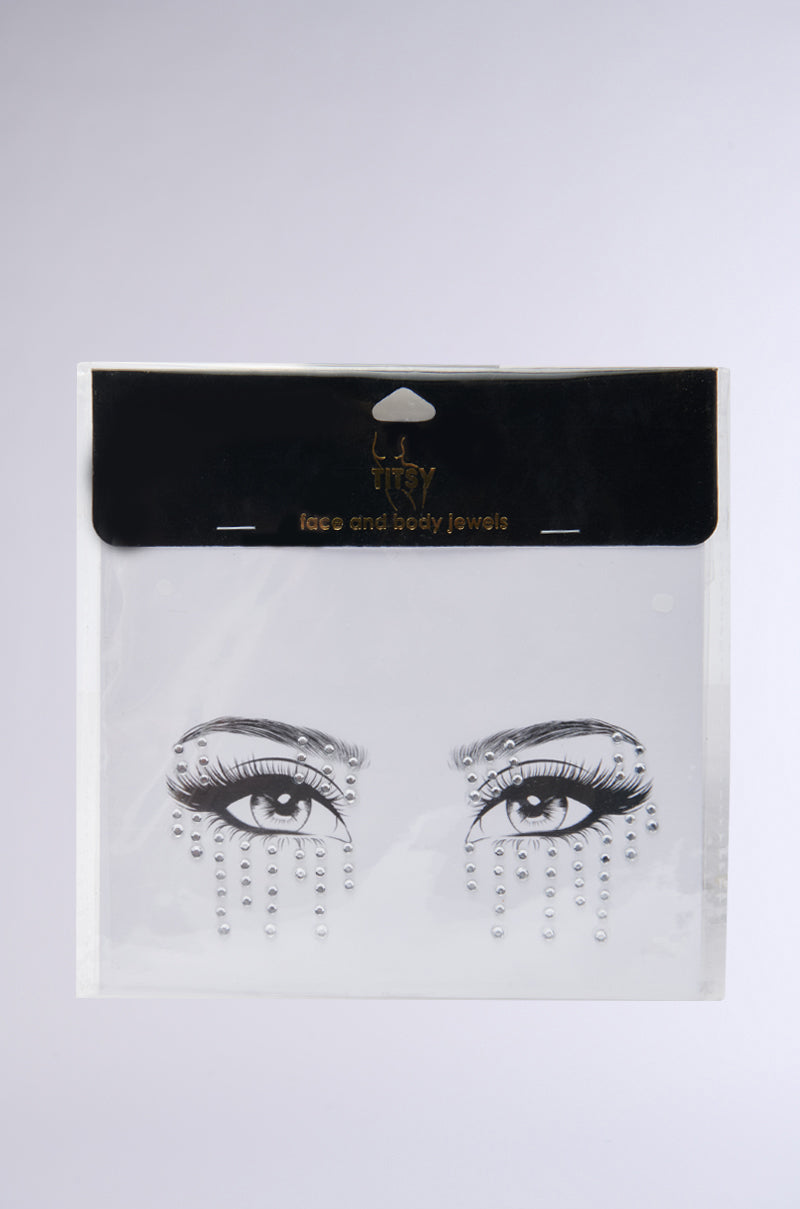 The CRY DIAMONDS FACE STICKERS, displayed on a white backdrop, feature rhinestones around illustrated eyes to mimic sparkling tears. The packaging is black and white with product details at the top.