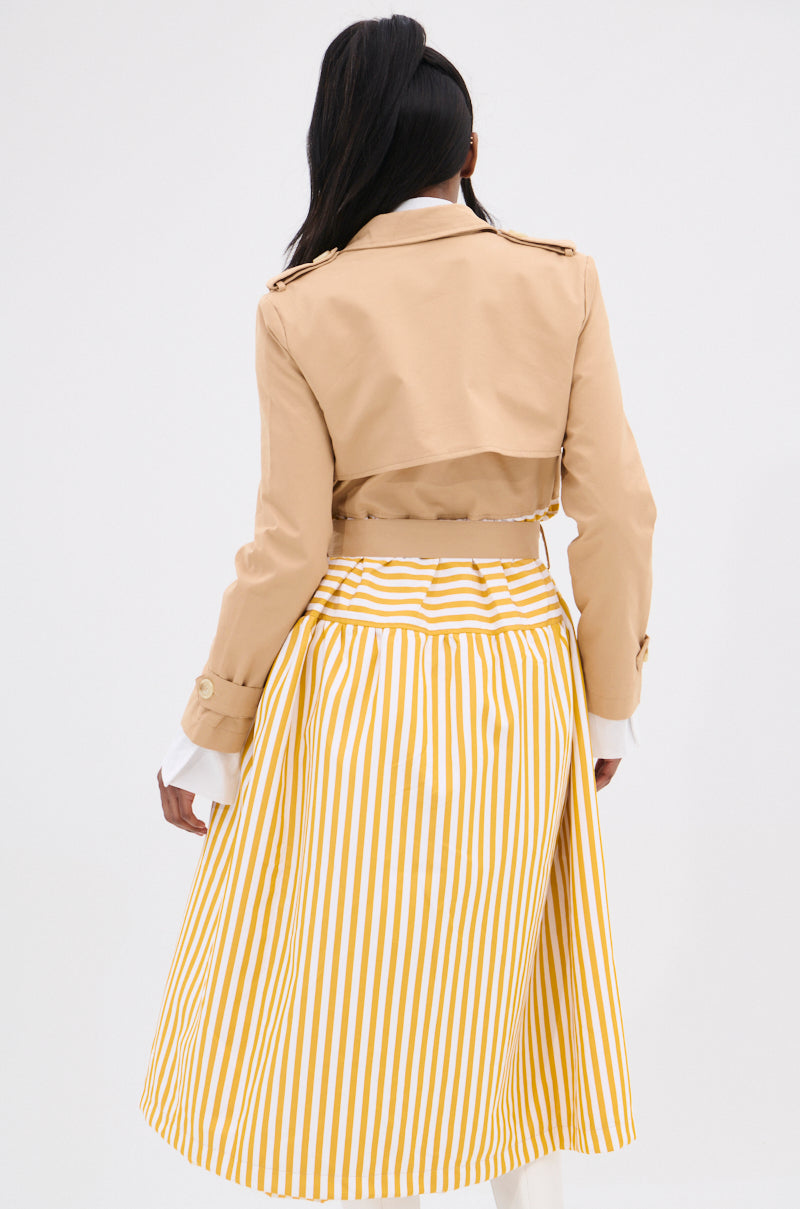 Rear view of a person with long dark hair in a tan cropped jacket over the LIKE A LADY STRIPED TRENCH skirt, emphasizing an hourglass figure against a plain white background.