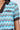 Close-up of the REBEL COLLARED TOP, showcasing its vibrant zigzag pattern with brown collar and cuffs. An oval 