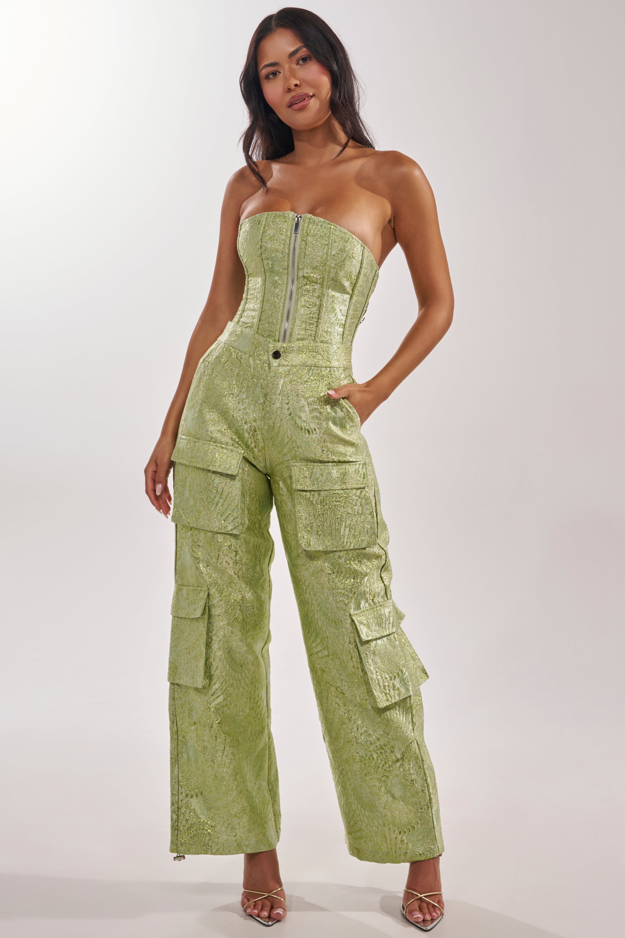 A woman poses in the ENVY ME BROCADE PANT, styled with strappy heeled sandals and loose, wavy hair worn down. 7