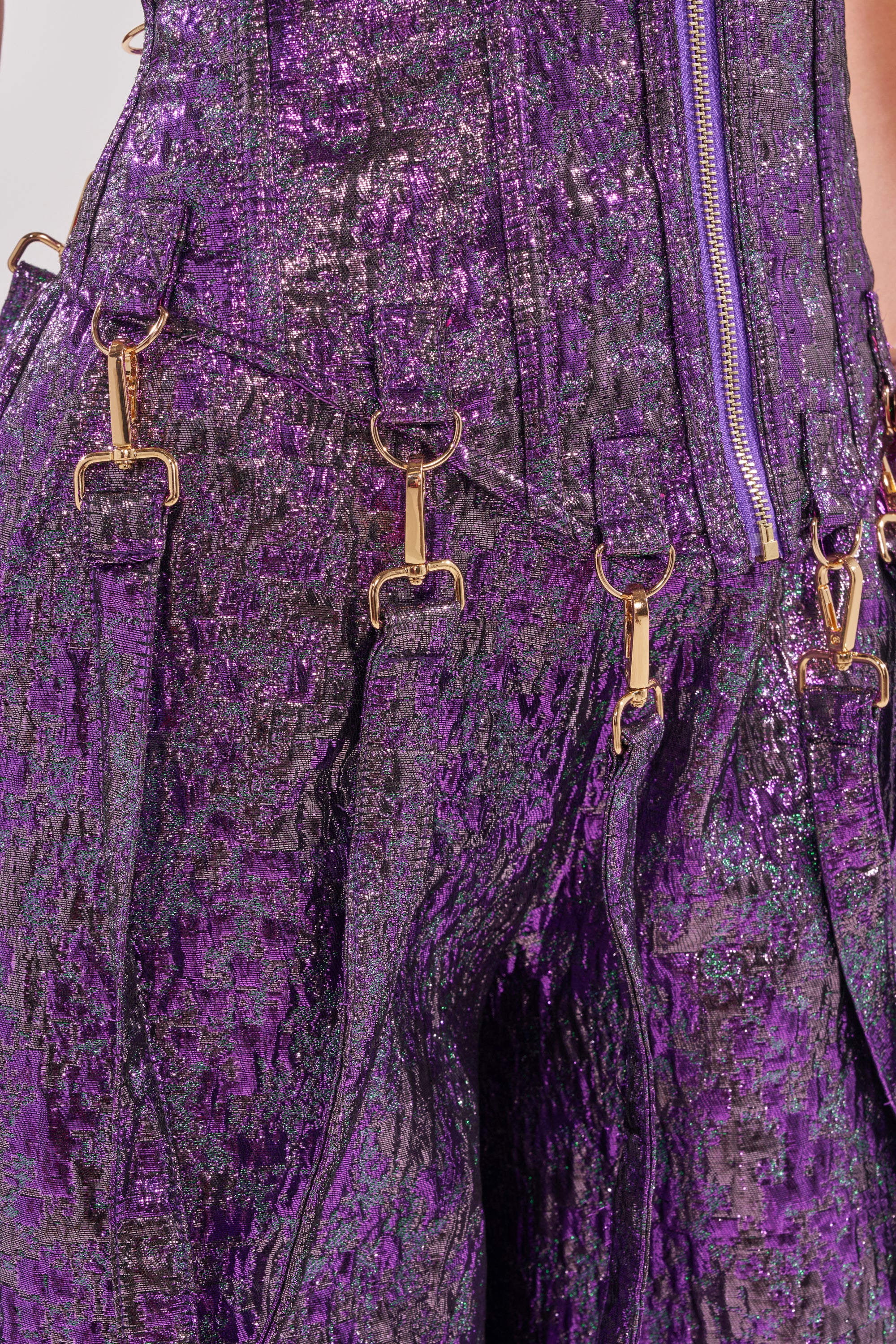 A close-up of a purple skirt styled with the ROYALTY BROCADE CORSET TOP, which cinches the waist. 9