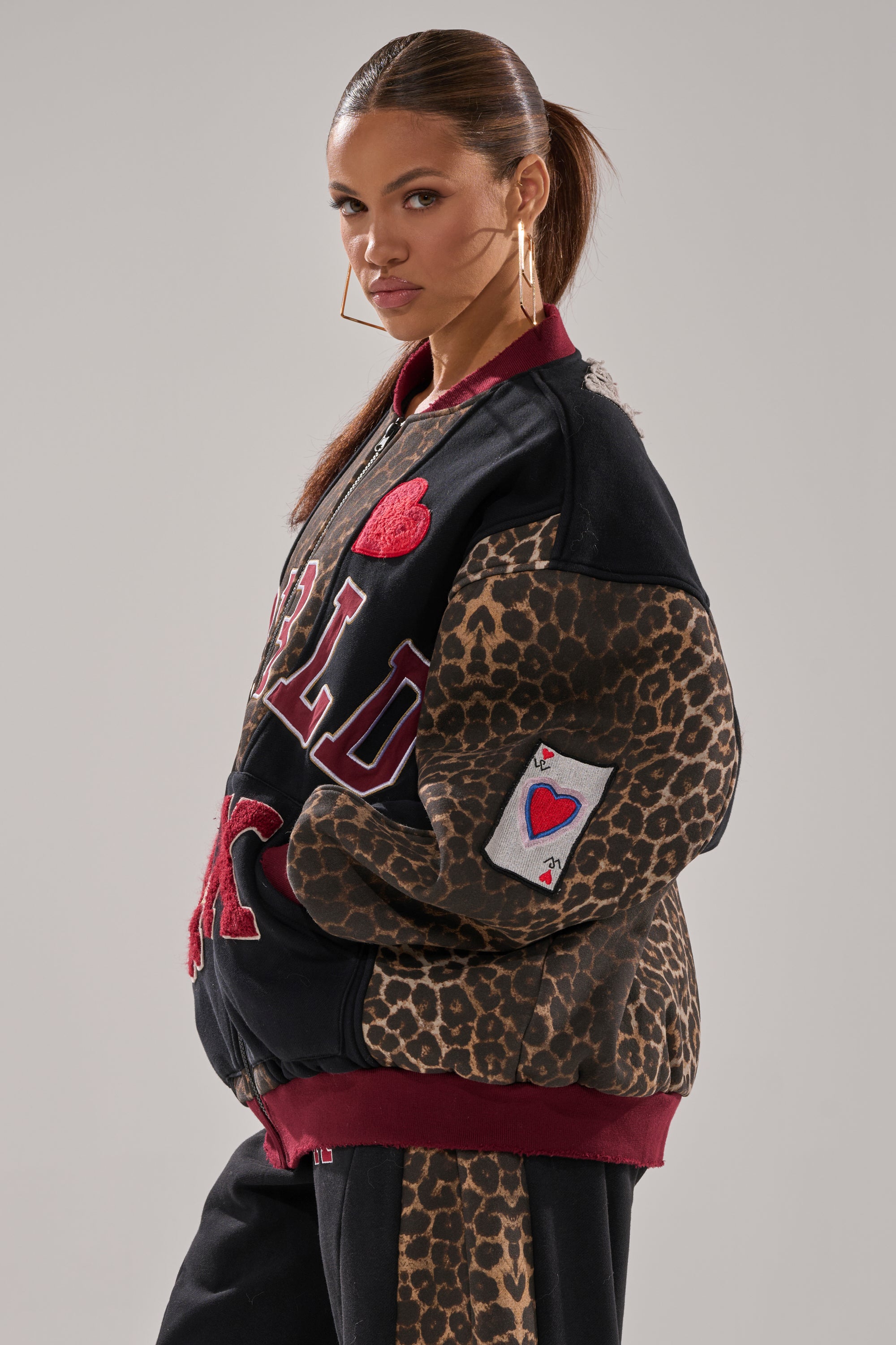 A woman in a WORLD HOLD ON ZIP UP SWEATSHIRT.