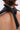 Close-up of a person’s upper back and neck with short brown hair, wearing the KRISTIN SATIN BLOUSE. The blouse features a black satin detail tied in a knot at the back. Background is plain and neutral.