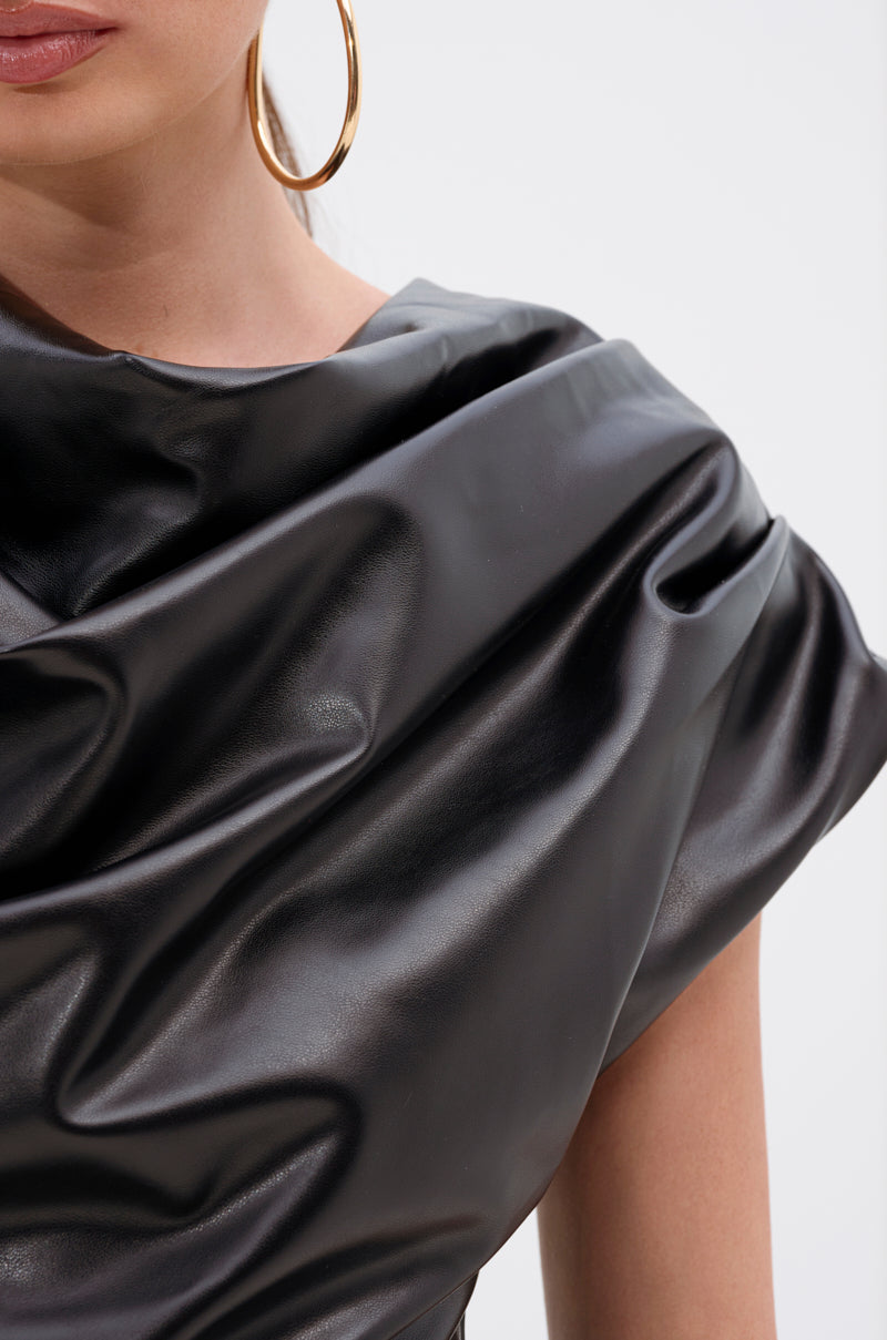 A close-up of a woman wearing the SHANNON FAUX LEATHER BODYSUIT with a shiny black cowl neckline, her hair pulled back, part of her face visible, and styled with a large gold hoop earring.
