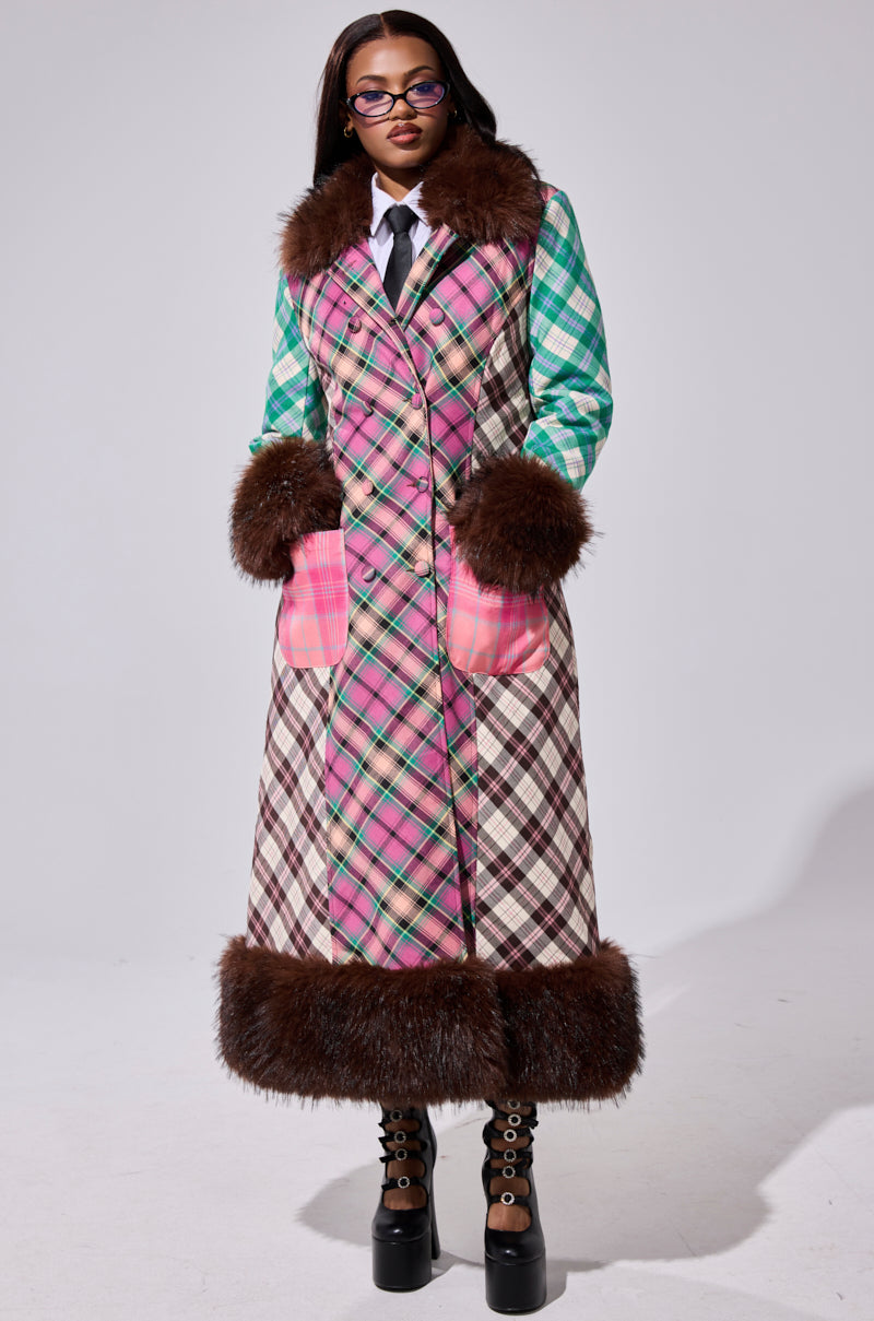 Wearing the SWEET THING PATCHWORK TRENCH with pink plaid and brown faux fur trim, paired with glasses, a white shirt, black tie, and platform boots creates a bold, stylish look.