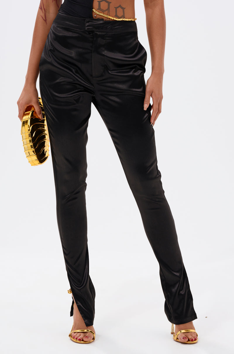 A person wears the DOWN FOR WHATEVER TROUSER and gold high-heeled sandals, holding a gold clutch purse, standing against a plain white background. 2