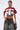 A woman styles the WINNING TEAM BUTTON DOWN, a red and white cotton boxy cropped shirt, with wide-leg faded jeans, large hoop earrings, slicked-back hair, visible torso tattoos, and a small black bag.