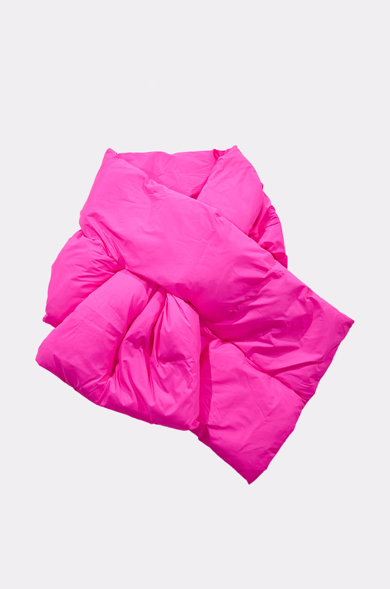 The WRAPPED UP PUFFER SCARF IN PINK is styled in a loose knot and displayed against a plain white background. 3