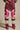 A person models ONLY THE COOLEST RHINESTONE PANT—sparkly, multicolored high-rise pants with pink, white, and brown geometric panels, cargo pockets, and leopard print accents—paired with animal print pointed-toe shoes. Only the lower body is visible.