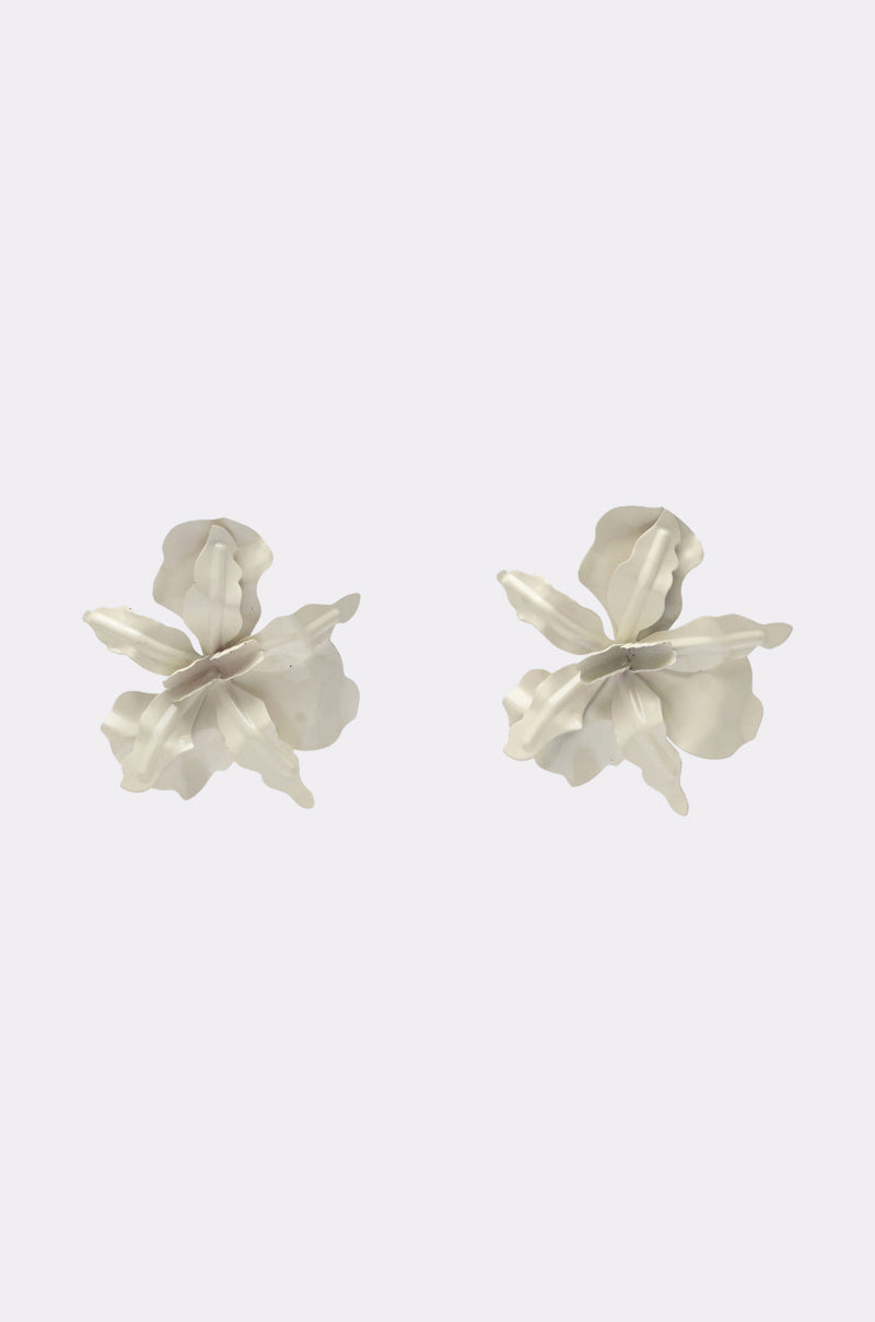 The NEVER SETTLE EARRING features a pair of silver, abstract floral earrings with layered, textured petals, shown against a white background—ideal for anyone wanting a distinctive white metallic accessory. 1