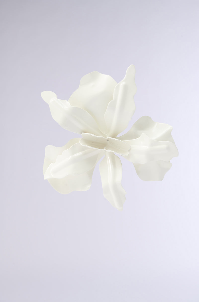 The NEVER SETTLE EARRING features a delicate, abstract petal design in white with soft curves and a subtle metallic base, showcased against a light gray background. 7