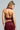 A person with long braided hair is wearing the 